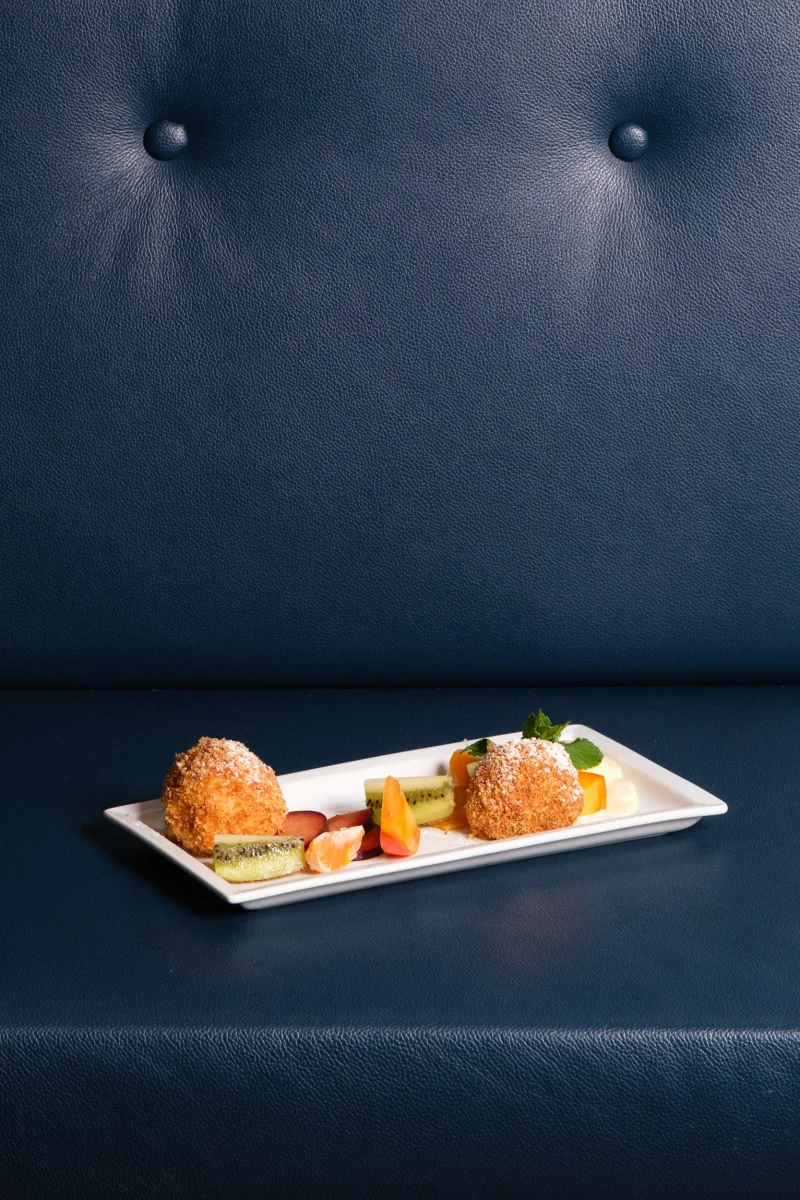 Piatto dolce su divano in pelle - fotografo ristorante stellato alto adige